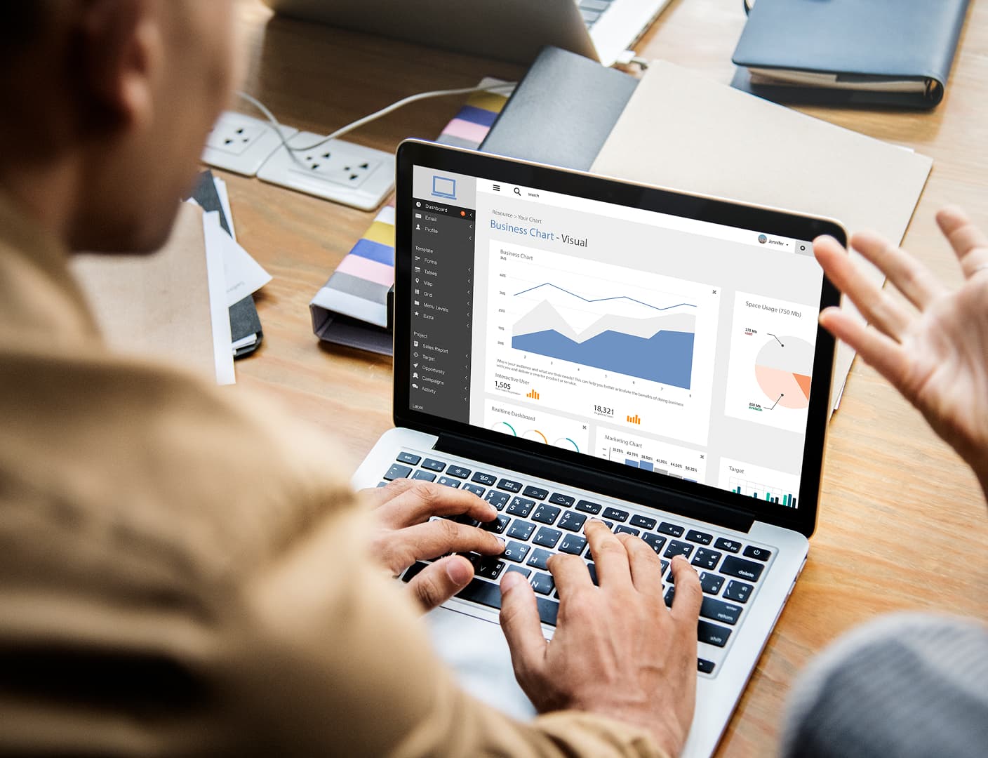 Professionals reviewing business charts on laptop, demonstrating what is low code, image by Novacura