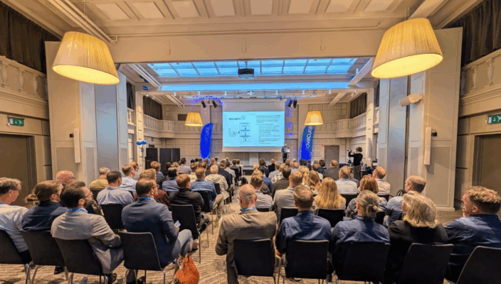 Photo from Novacura Flow User Conference 2025 featuring the conference room from the back during one of the presentations