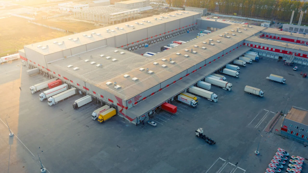 Warehouse operator using a mobile tablet to process real-time logistics and inventory data integrated with Infor M3 ERP.